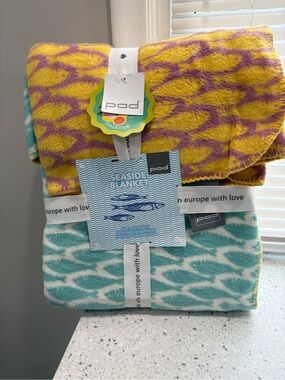 New in package Pad Seaside Blanket- multi color featuring coastal fish